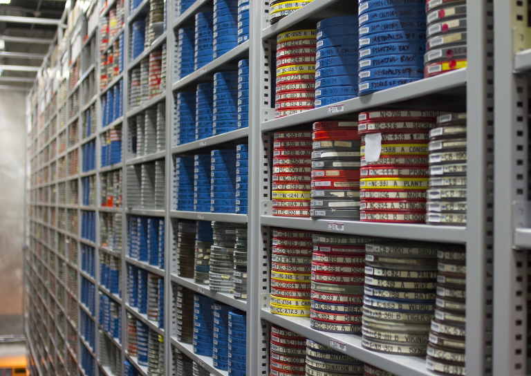 photo of film reels on shelves at IU's Moving Image Archive