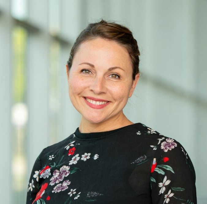 photographic portrait of white woman with brown hair in a updo and a floral outfit