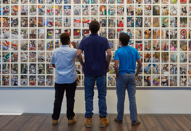 People in front of huge grid of colorful images