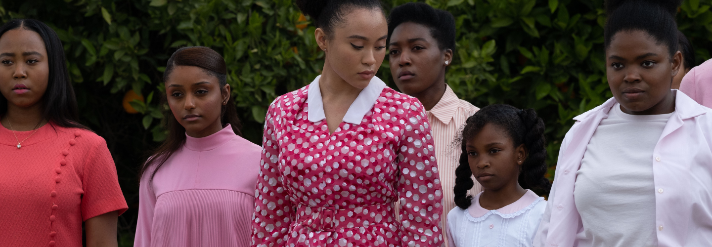 African-American girls wearing pink and red clothing stand together