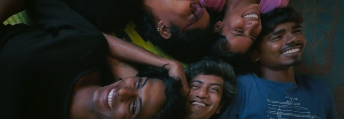 Five people with medium-dark skin tone recline, smiling, enjoying the company. 