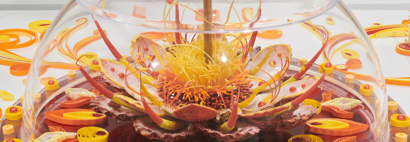 orange and yellow flower-looking multimedia sculpture