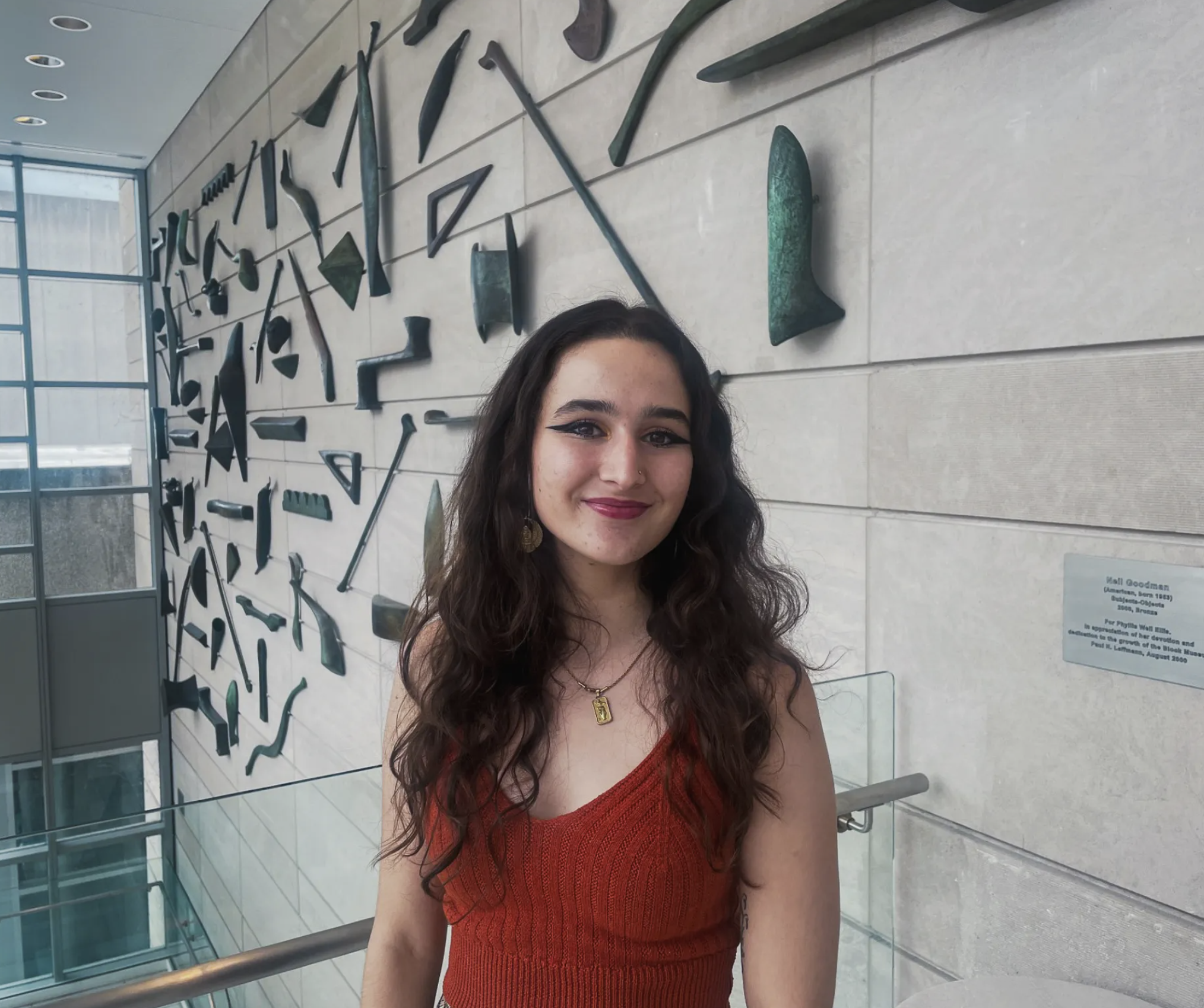 Marisa Cruz Branco smiling in front of a wall in the Block